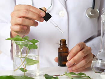 A doctor preparing homeopathic medicine in a laboratory.
